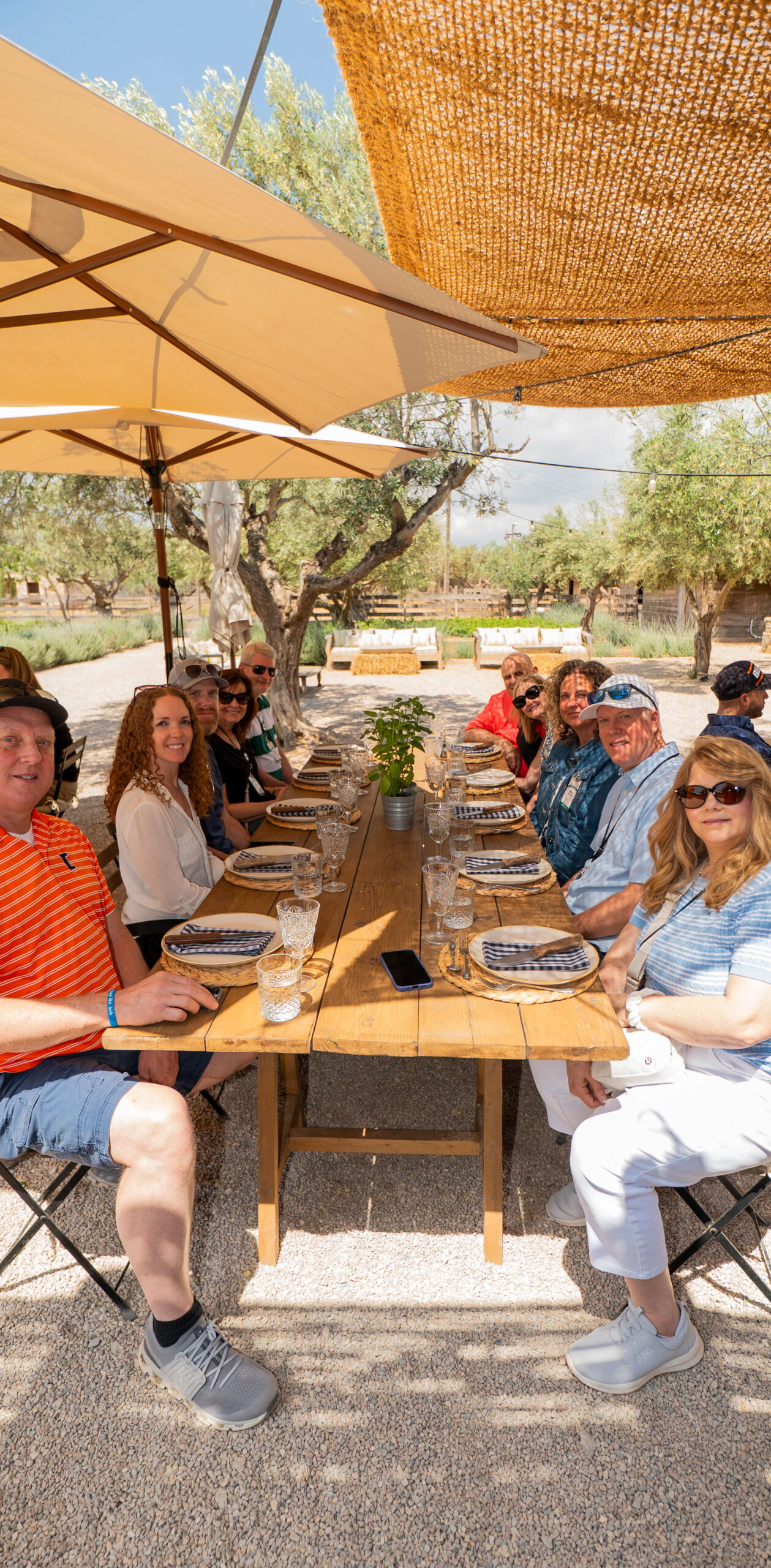 Guests enjoying an outdoor farm dinner at a company partner retreat